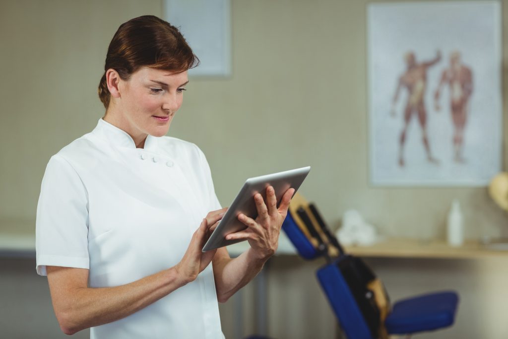 Physiotherapist using digital tablet